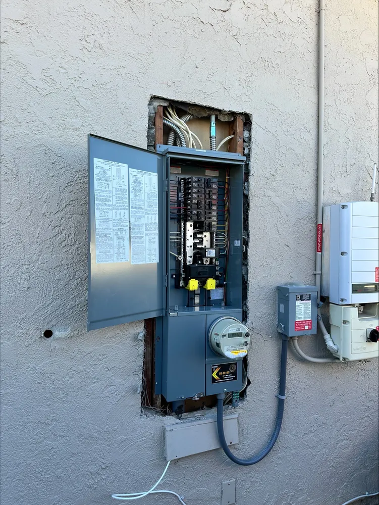Open Challenger electrical panel with breaker handles in a South Orange County home