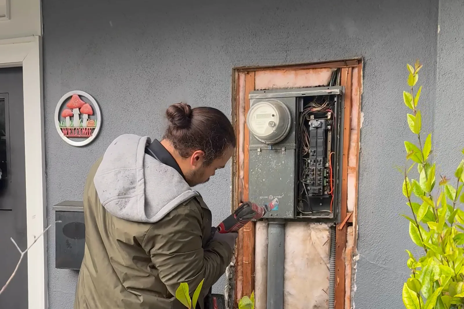 An older electrical panel and meter being replaced on an Orange County home for insurance compliance