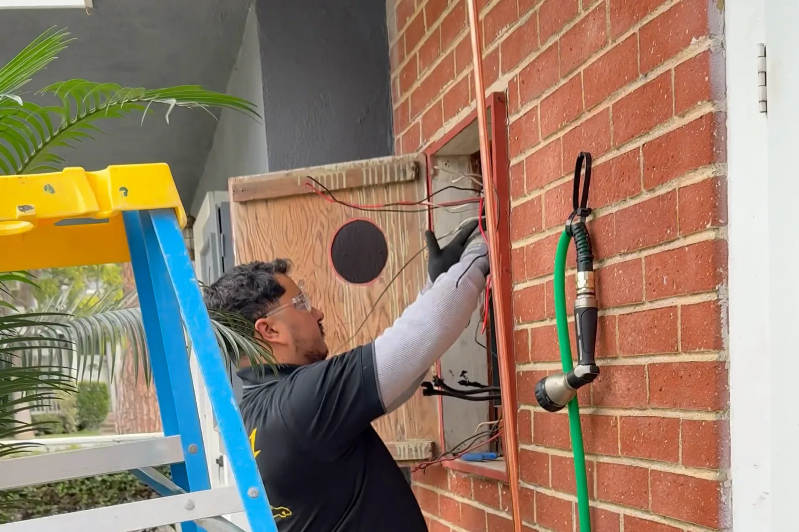 A Panel Pros technician replacing an electrical panel on a community building for insurance compliance